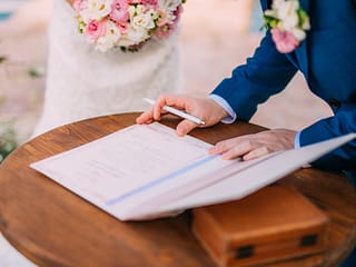 newlyweds-put-their-signatures-in-the-act-of-registering-marriage-min